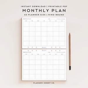 May include: Two white A5 monthly planner pages with black grid lines, headers for days of the week, and a year line. The text reads MONTHLY PLAN, A5 PLANNER SIZE, RING-BOUND, and PLANNER INSERT CO. A wooden pencil is positioned to the right of the pages.