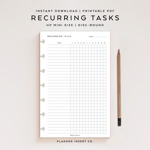 May include: A white planner insert with the text "RECURRING TASKS" and a grid for tracking tasks. A wooden pencil rests beside the planner. The text "INSTANT DOWNLOAD | PRINTABLE PDF" is at the top. The planner is disc-bound.