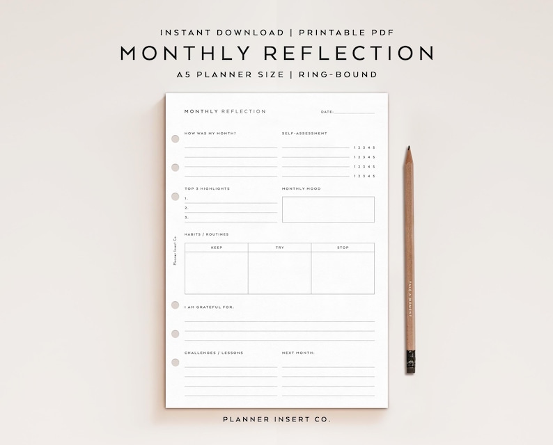 May include: A white A5 planner insert with the text "MONTHLY REFLECTION" and sections for self-assessment, highlights, and habits. A wooden pencil rests beside the planner. The top of the image reads "INSTANT DOWNLOAD | PRINTABLE PDF".