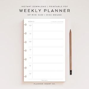 May include: A white weekly planner with a minimalist design, featuring sections for each day of the week. The planner is disc-bound and includes the text "WEEKLY PLANNER" and "HP MINI SIZE | DISC-BOUND". A wooden pencil rests beside the planner.