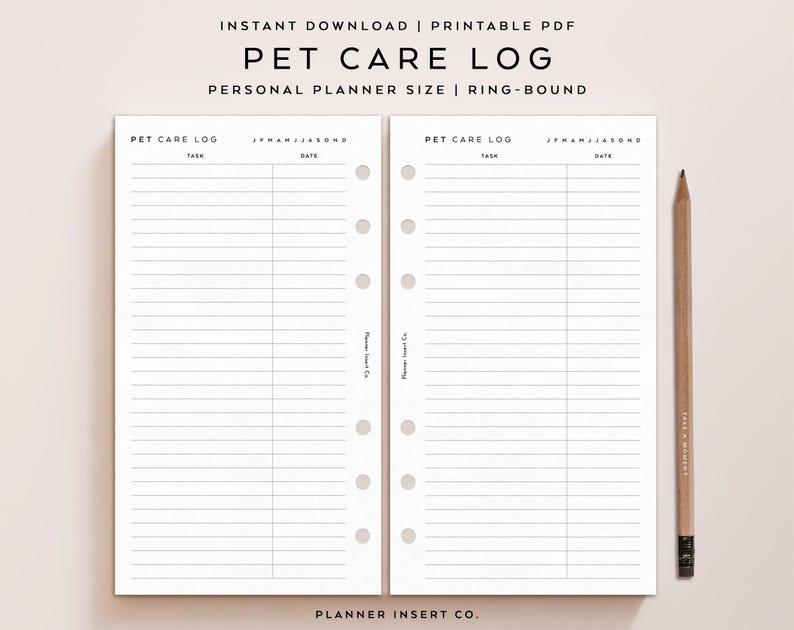 May include: Two white pages of a pet care log planner insert with black text and lines. The pages feature headers for task and date, months of the year, and five circular holes for ring binding. A wooden pencil is positioned to the right side.
