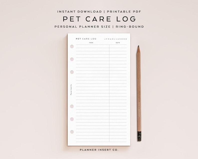 May include: A white printable pet care log planner insert with six ring-bound holes on the left side. The page features the text PET CARE LOG, TASK, DATE, and J F M A M J J A S O N D. A wooden pencil is positioned vertically to the right of the page.