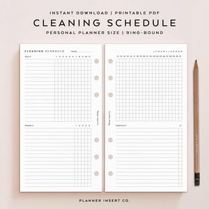 May include: A printable PDF cleaning schedule for a personal ring-bound planner. The white pages feature black text and grids for daily, weekly, and monthly tasks. A wooden pencil is positioned to the right of the two planner pages.