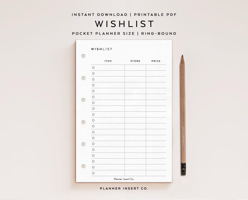 May include: A white wishlist planner insert with a grid for items, stores, and prices. The text "WISHLIST" is at the top. A wooden pencil rests on the right. The planner is ring-bound and pocket-sized.