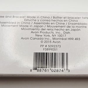 May include: A white product box with black accents, featuring printed text in multiple languages. The text includes details about the case, bracelet, and watch movement origin, along with the manufacturer's information and a barcode.