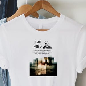 May include: White t-shirt featuring the name "Juan Rulfo" with a portrait and quote. The graphic includes a black and white image and text that reads "Nothing can last forever; there isn't any memory no matter how intense that doesn't fade out at last."