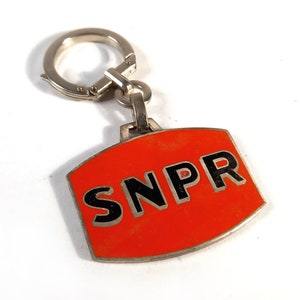 Vintage French red metal advertising keychains from the 50&#39;s SNPR