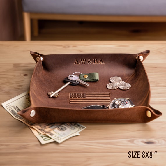 A hand-embossed leather valet tray that actually looks like something from a high-end men's boutique — personalized, desk-ready, and with nearly 3K favorites proving real demand.