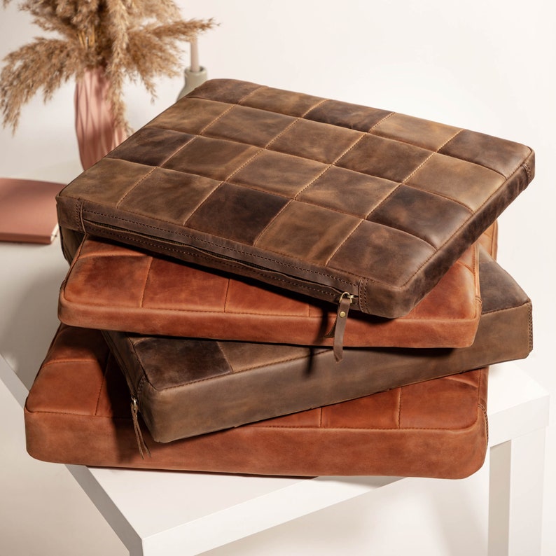 Four leather cushions with zippers: two brown and two copper, square or custom size for chairs and armchairs.