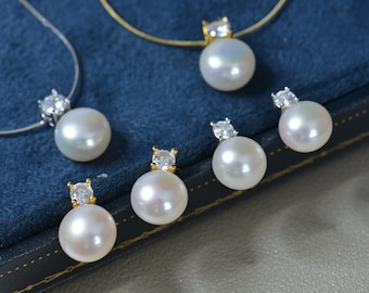 May include: A set of pearl jewellery featuring a necklace, earrings, and a pendant. Each piece has a white pearl with a small, clear, cubic zirconia accent.