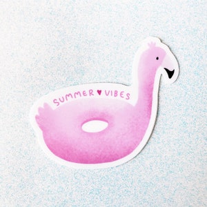 May include: Pink inflatable flamingo pool float with the text "SUMMER ♥ VIBES" on it.