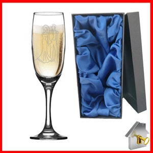 Personalised Wedding Gift. Champagne flute engraved on both sides with unique design. Bride& Groom image one sidewith Bride & Groom names on the reverse, entwined wedding rings image and the date of the wedding below. Optional Display Box option.