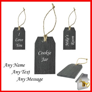 May include: Slate tags with jute twine hangers. One tag reads "I Love You", another says "Cookie Jar", and a third says "Mike's Room". Additional text states "Any Name, Any Text, Any Message". A house icon with a key is also present.