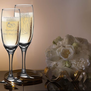 Personalised Wedding Gift. Champagne flute engraved on both sides with unique design. Bride& Groom image one sidewith Bride & Groom names on the reverse, entwined wedding rings image and the date of the wedding below. Optional Display Box option.