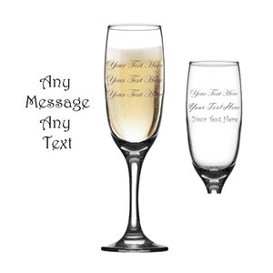 May include: Two champagne flutes, one filled with champagne, with the text "Your Text Here" engraved on each.