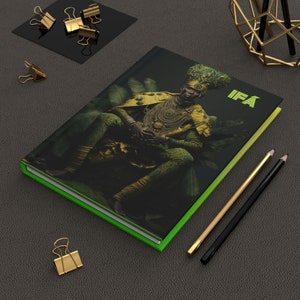 May include: A green and yellow book with a photo of a person wearing a gold crown and a yellow and green outfit. The book has the word "IFA" on the cover.