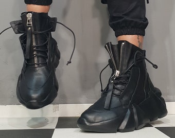 May include: Black leather ankle boots with a zipper up the front and a chunky platform sole.