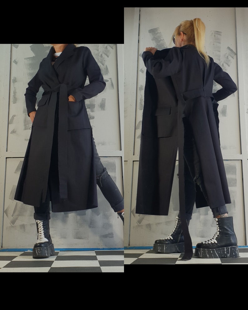 May include: A long black coat with a belt and a long slit in the back. The coat is made of a soft, comfortable fabric and has a relaxed fit.