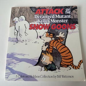 May include: A book cover from the Calvin and Hobbes Collection by Bill Watterson. The title is "Attack of the Deranged Mutant Killer Monster Snow Goons." The illustration shows Calvin and Hobbes in a snowy scene, with a snowman in the background.