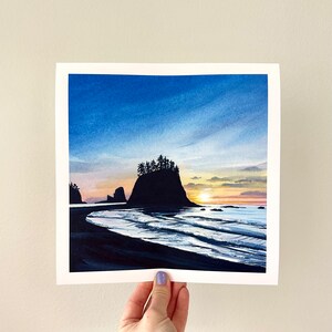 May include: A watercolor painting of a sunset over the ocean with a large rock formation in the foreground. The sky is a mix of blue, orange, and pink, and the water is a deep blue. The rock formation is silhouetted against the sky.