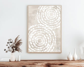 May include: A framed abstract print with a beige background and white swirling patterns. The print is hanging on a white wall above a wooden console table with two vases and a book.