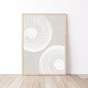 May include: A framed print featuring a white geometric design on a light grey background. The design consists of two overlapping circles with intricate patterns.