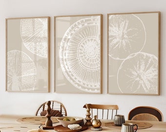May include: Three framed prints with a beige background and white circular designs. The prints are hanging on a white wall above a wooden dining table with six chairs. The chairs are made of woven rattan and have a natural wood frame.