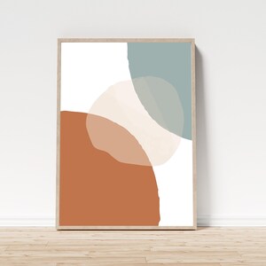 May include: Abstract art print featuring three overlapping shapes in shades of brown, beige, and blue. The shapes are irregular and organic, creating a modern and minimalist design.