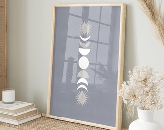 May include: A framed print with a light blue background and a white sun and moon design. The print is hanging on a wall above a light wood bench with a woven rattan top. There are two woven baskets and a white vase with dried flowers on the bench.