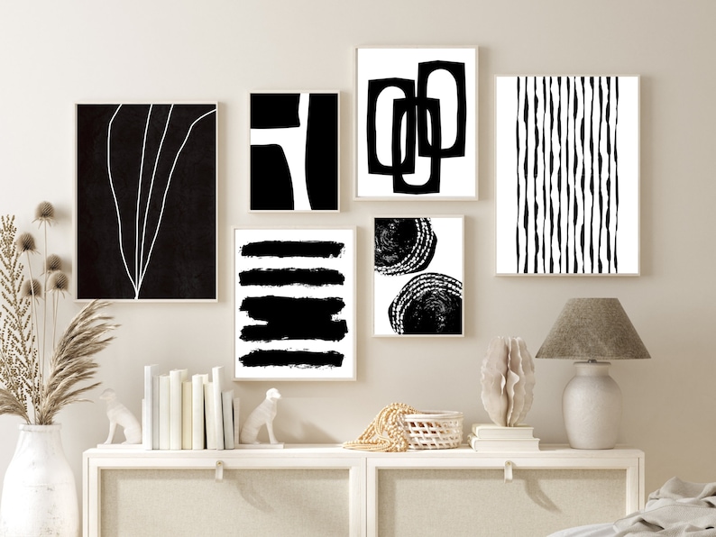 May include: A set of six black and white abstract art prints with geometric and organic shapes. The prints are framed and hung on a light beige wall.