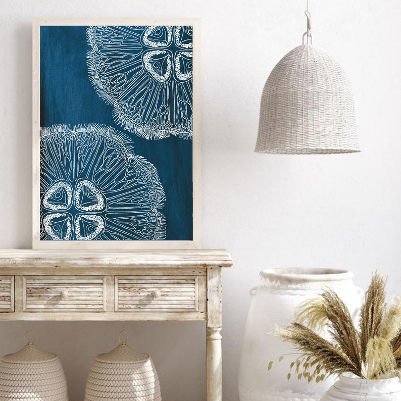 Puede incluir: Una impresi&oacute;n enmarcada con un fondo azul y dos ilustraciones estilizadas blancas de medusas.