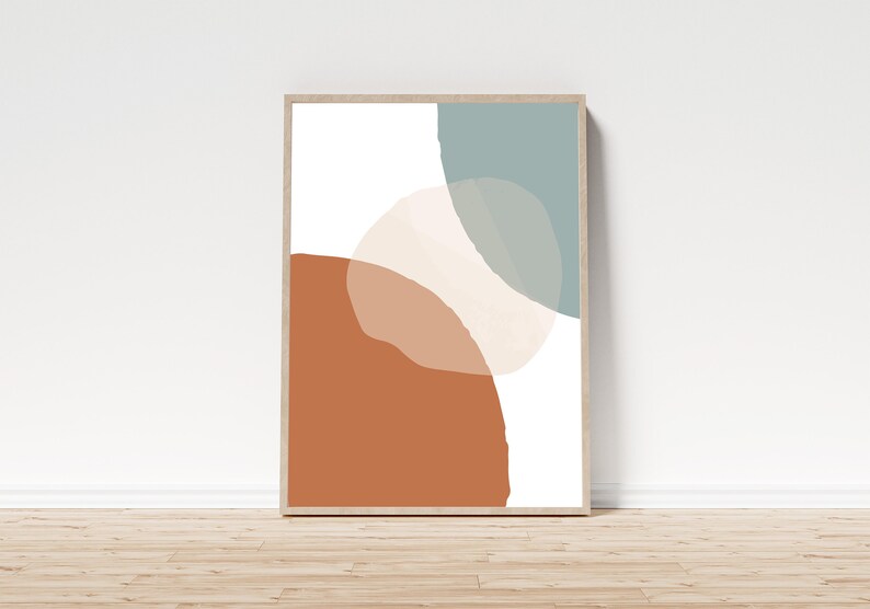 May include: Abstract art print featuring three overlapping shapes in shades of brown, beige, and blue. The shapes are irregular and organic, creating a modern and minimalist design.