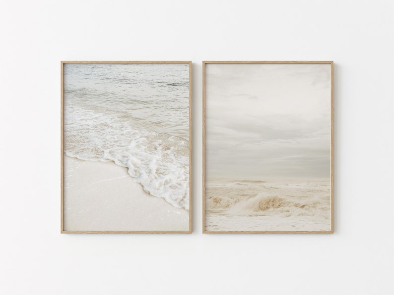 May include: Two framed prints of a beach scene. The left print shows a close-up of foamy waves crashing on the shore. The right print shows a wider view of the ocean with waves and a cloudy sky.