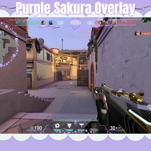 May include: A first-person perspective of a video game, displaying a player holding a gold and black gun. The game's interface is visible, including a map of the level and the player's health and ammo. The game's environment is a city street with buildings on either side.