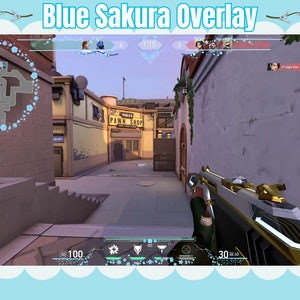 May include: A first-person view of a video game with a blue sakura overlay. The game displays a map, player information, and a weapon. The text "Blue Sakura Overlay" is at the top of the image.