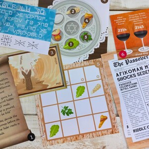 Op de afbeelding: Een set Pessach-spelkaarten met verschillende activiteiten, waaronder een woordzoeker, een raadsel, een matchspel en een krantenartikel over de Afikoman. De kaarten zijn versierd met traditionele Pessach-symbolen, zoals een Seder-bord, matze en een Davidster.
