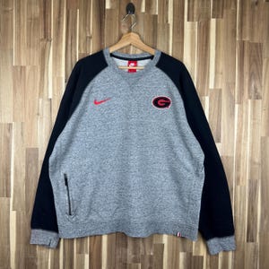 grey nike sweatshirt with red tick