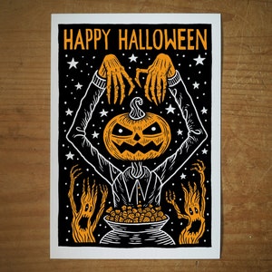 May include: A black and white illustration of a jack-o'-lantern with outstretched arms holding a cauldron filled with candy. The text "HAPPY HALLOWEEN" is at the top of the image.