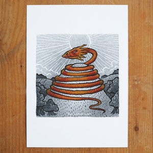 May include: A red and orange dragon coiled around a hilltop, with a sun shining in the background. The dragon's head is facing the viewer, and its eyes are closed. The hilltop is covered in grass and trees.