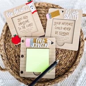 May include: Wooden teacher appreciation gifts with personalized names and messages. One frame has an apple accent and the text "You are awesome, to the core!" Another has a pencil accent and the text "Your influence could never be erased!" A third frame has a pencil accent and a notepad.