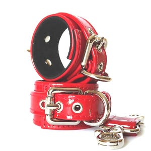 Seduce with Style: Red Patent Leather Wrist Cuffs for Elegant Bondage Play