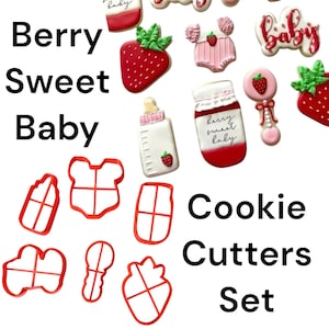 May include: A collection of baby-themed cookies and cookie cutters. The cookies include a strawberry, baby bottle, and onesie. The cookie cutters are red and shaped like a baby bottle, onesie, and strawberry. Text on the image reads "Berry Sweet Baby Cookie Cutters Set."