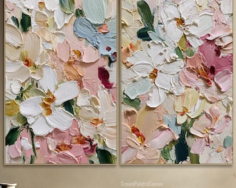 May include: Two framed floral paintings with thick brushstrokes in shades of white, pink, peach, and blue. The artwork is displayed above a wooden bench and next to a vase. The overall theme is floral art.