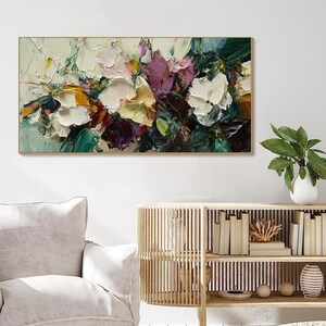 May include: Abstract painting with a floral theme. The painting features a variety of colors, including white, yellow, green, purple, and brown. The paint is applied in thick strokes, creating a textured effect.