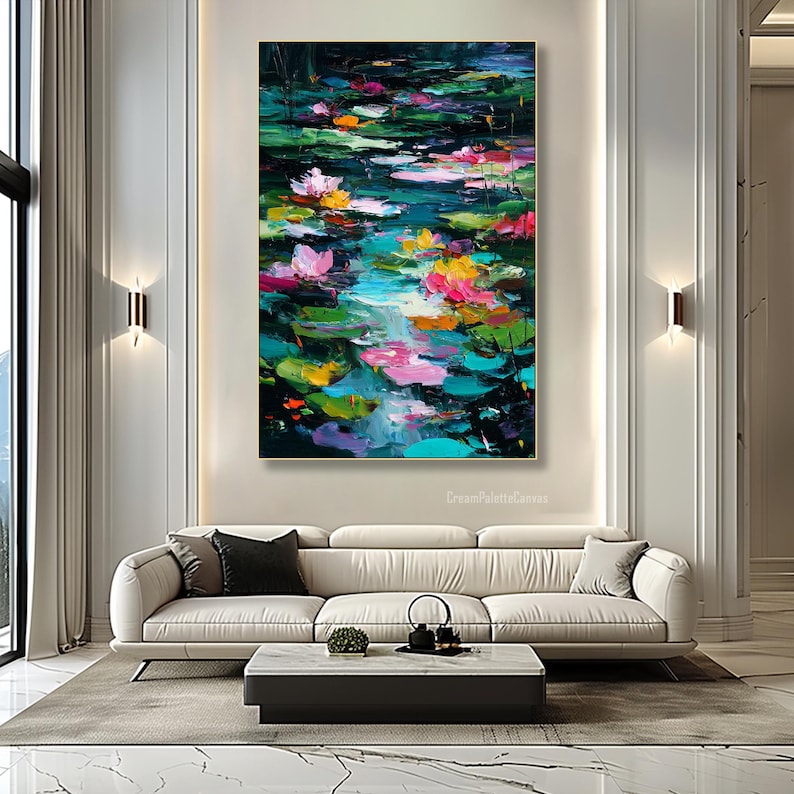 May include: Large abstract painting of a pond with lily pads and flowers. The artwork features vibrant colors including pink, yellow, and teal. The painting is displayed above a white sofa in a modern living room.