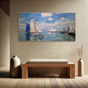 May include: A framed canvas print of a seascape featuring sailboats on the water under a blue sky with clouds. The artwork has a classic, impressionistic style. The print is displayed above a wooden bench in a room with neutral-toned walls.