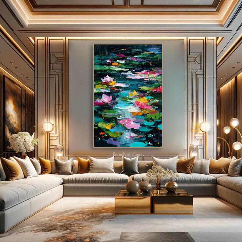 May include: Large abstract painting of a pond with lily pads and flowers in shades of pink, yellow, and green. The artwork is displayed in a modern living room with neutral-toned furniture and gold accents. The painting is the focal point of the room.