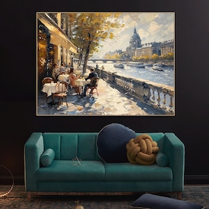 May include: A painting depicting a Parisian cafe scene, featuring people seated at tables outside. The cafe is situated on the banks of the River Seine, with a view of the city skyline in the background. The painting is executed in a loose, impressionistic style, using vibrant colours and brushstrokes.