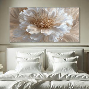 May include: Large floral canvas art featuring a close-up of a flower with white and beige petals. The artwork has a textured appearance, with a light brown background. The painting is framed in a silver-colored frame.