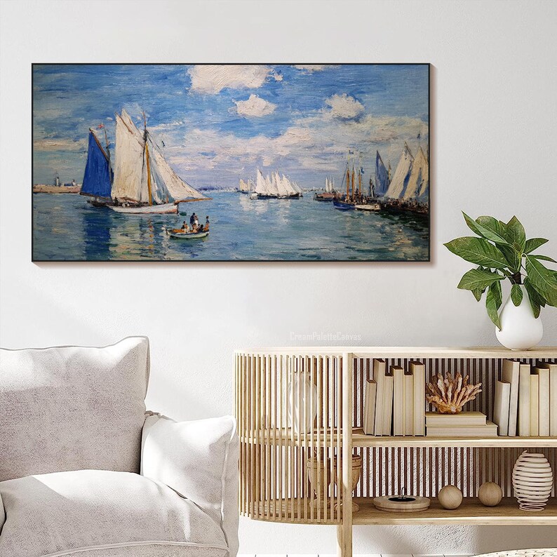 May include: A framed canvas print of a seascape featuring sailboats on a blue ocean under a cloudy sky. The painting has a classic, impressionistic style, with visible brushstrokes and a soft color palette. A small boat with people is in the foreground.